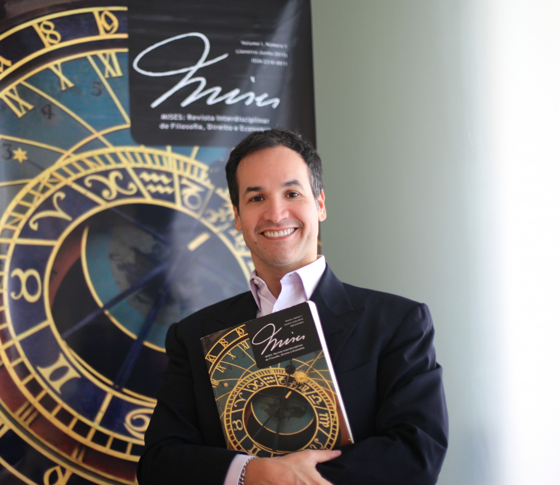 Helio Beltrão, President and Founder of Instituto Mises Brazil with a copy of the first volume of their journal.